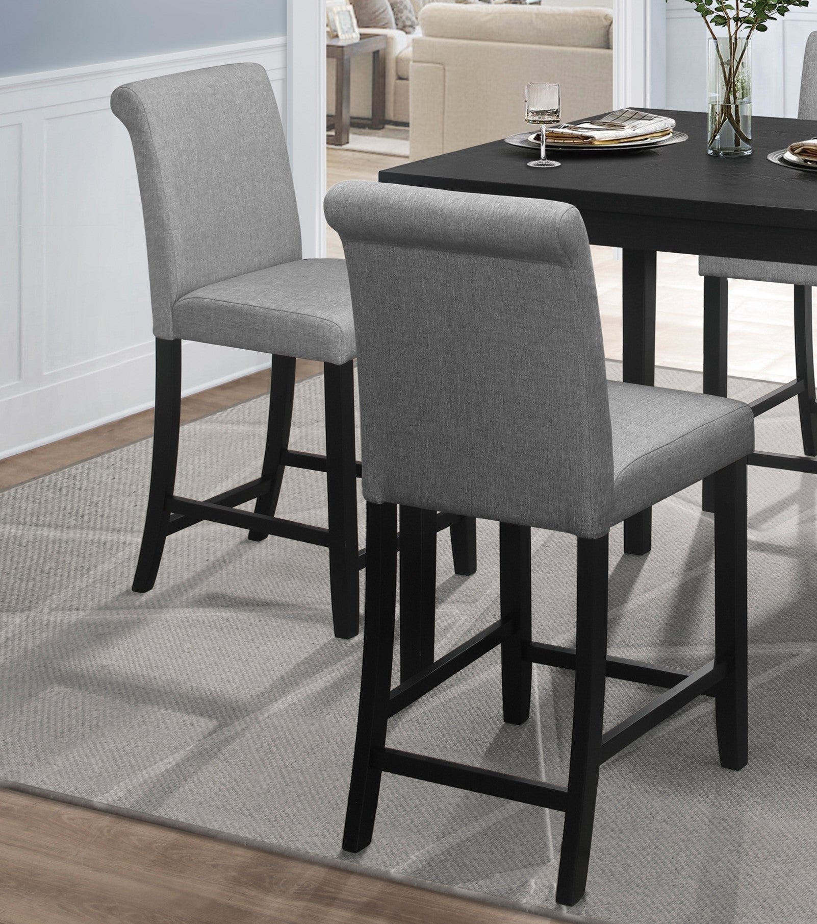 Gray upholstered bar stool with black wooden legs for modern kitchen counter seating