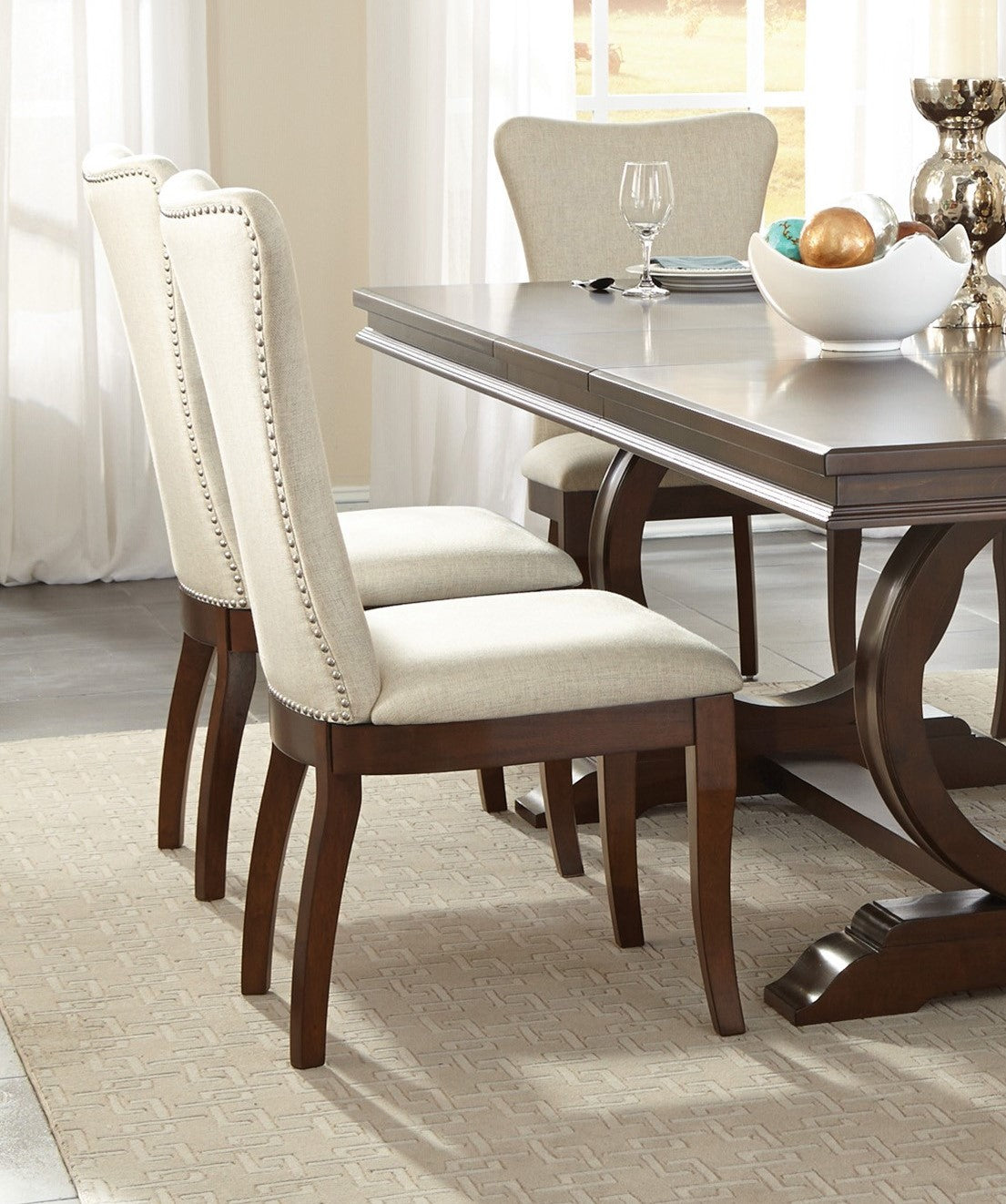 Tufted upholstered dining chair with nailhead trim and dark wood legs