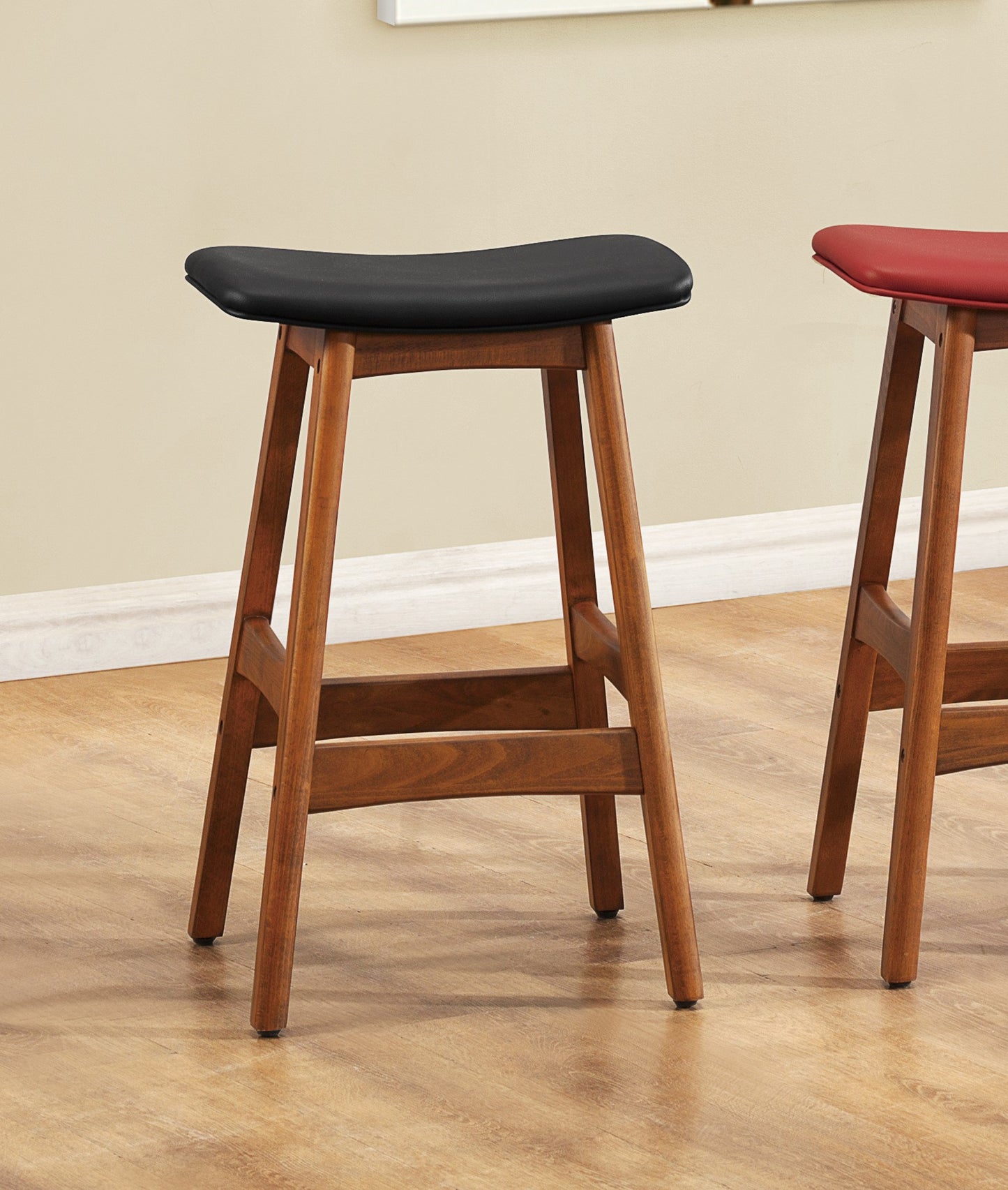 Black leather saddle stool with walnut wood base