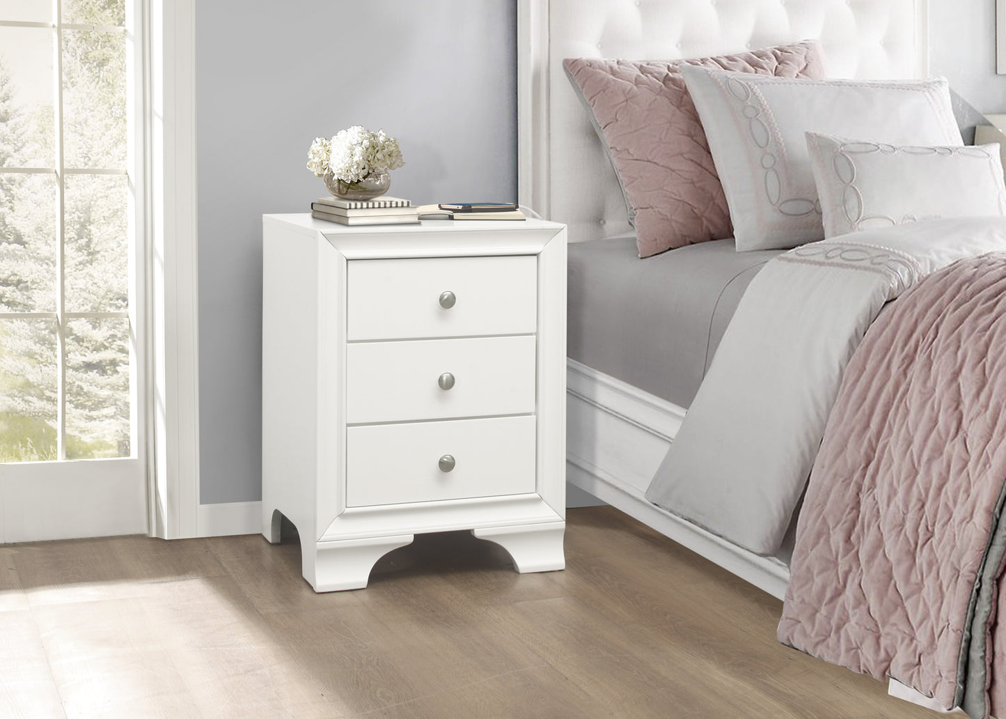 White bedside table with three drawers and silver knobs perfect for bedroom storage