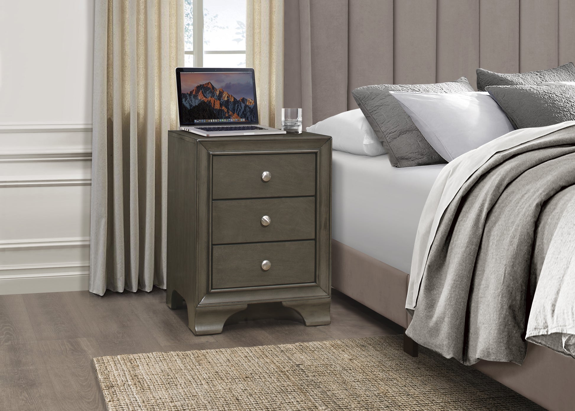 Grey wood bedside table with three drawers and silver knobs