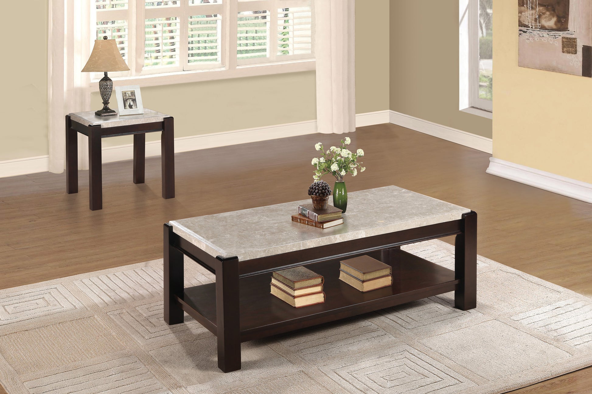 Dark wood coffee table with a faux marble top and lower shelf holding decorative books
