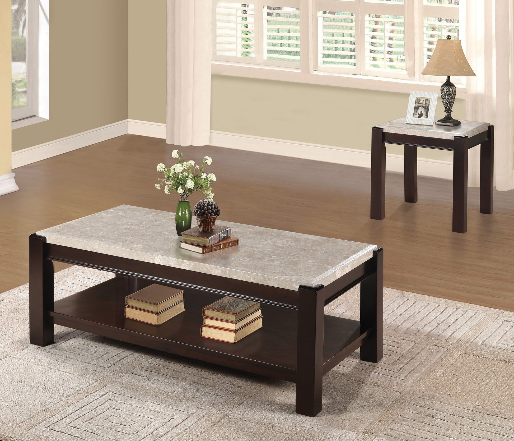 Dark wood coffee table with faux marble top and lower shelf holding books