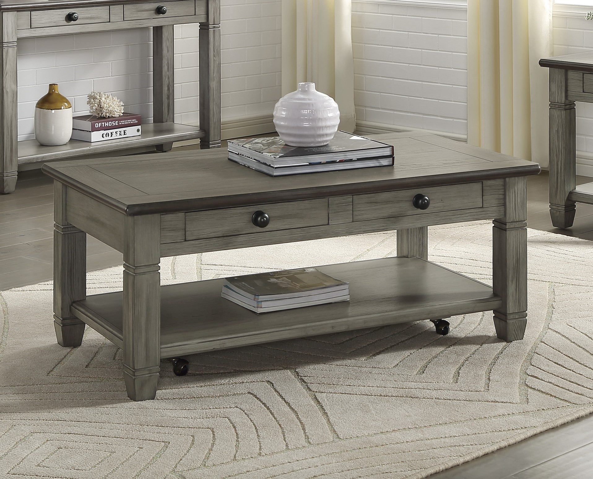 Gray wooden coffee table with two drawers a lower shelf and casters