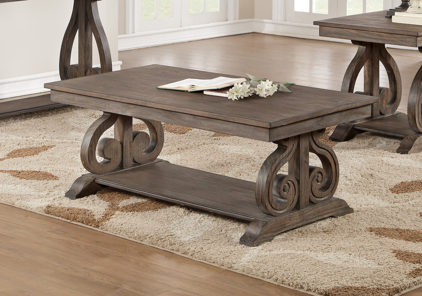 Dark wood coffee table with ornate scroll legs and lower shelf for living room decor