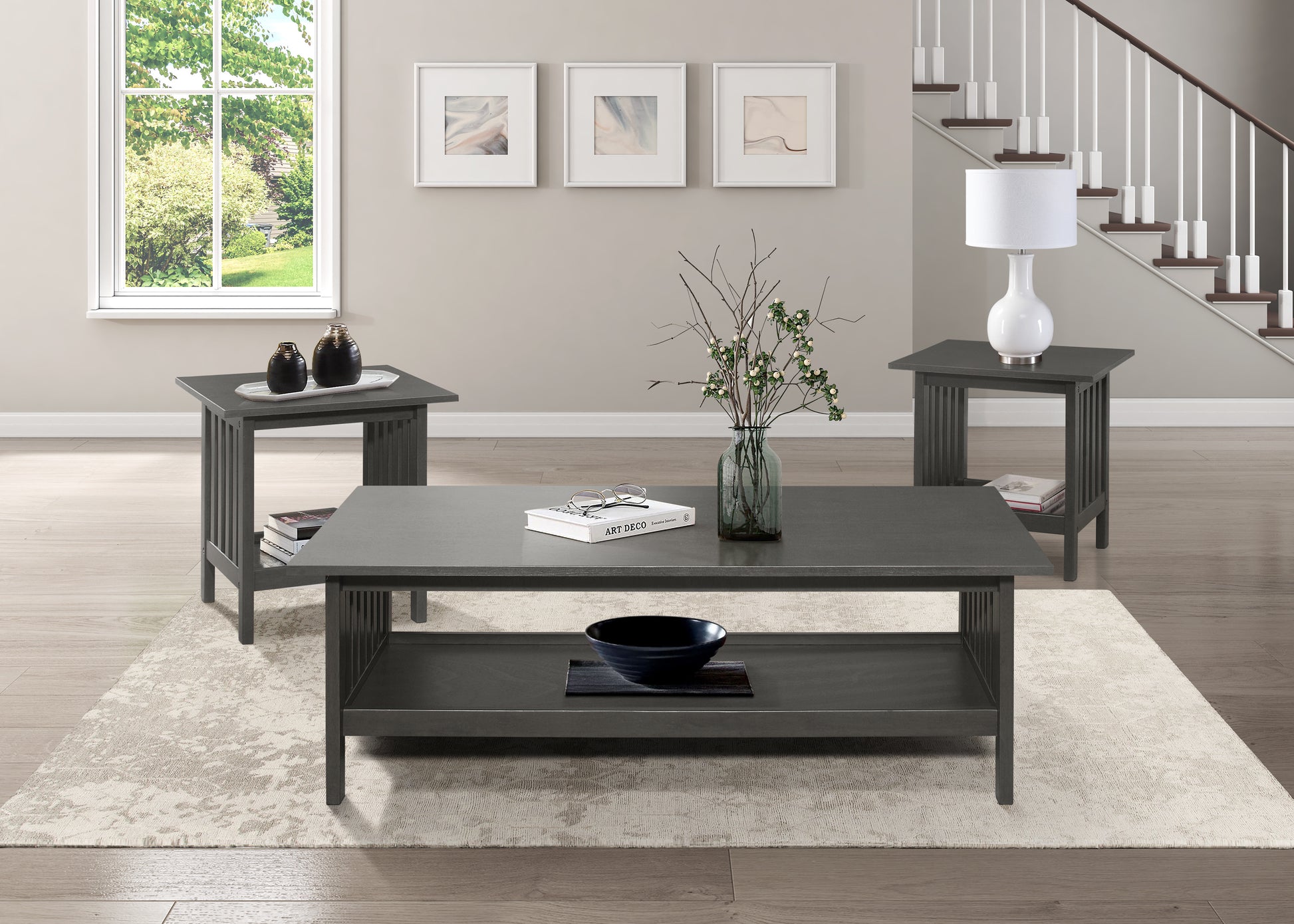 Gray missionstyle coffee table with lower shelf holding books and a decorative bowl