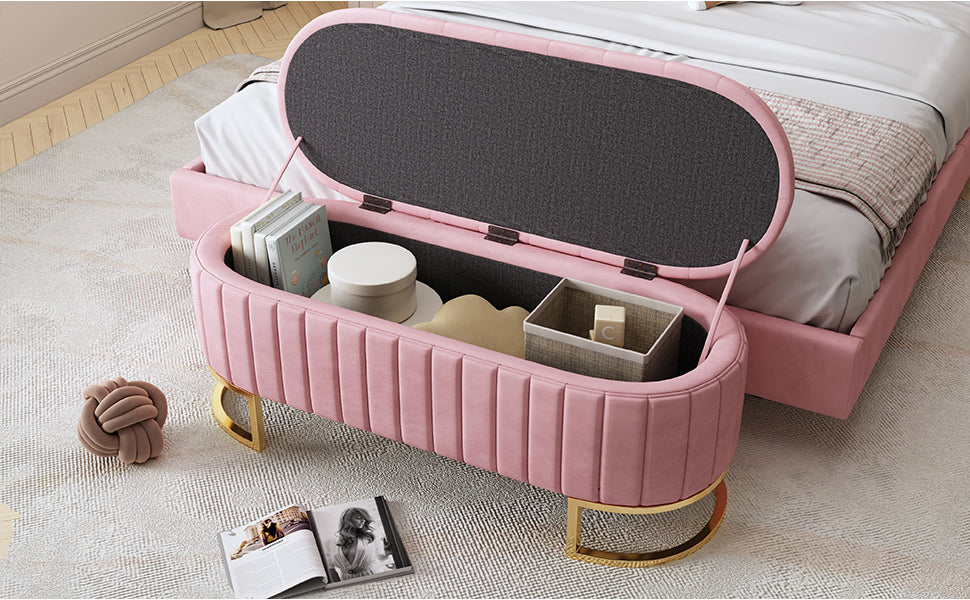 Pink velvet storage bench with gold legs open for books and toys