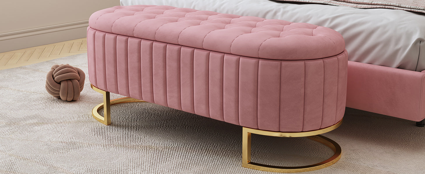 Pink velvet storage bench with tufted lid and gold base