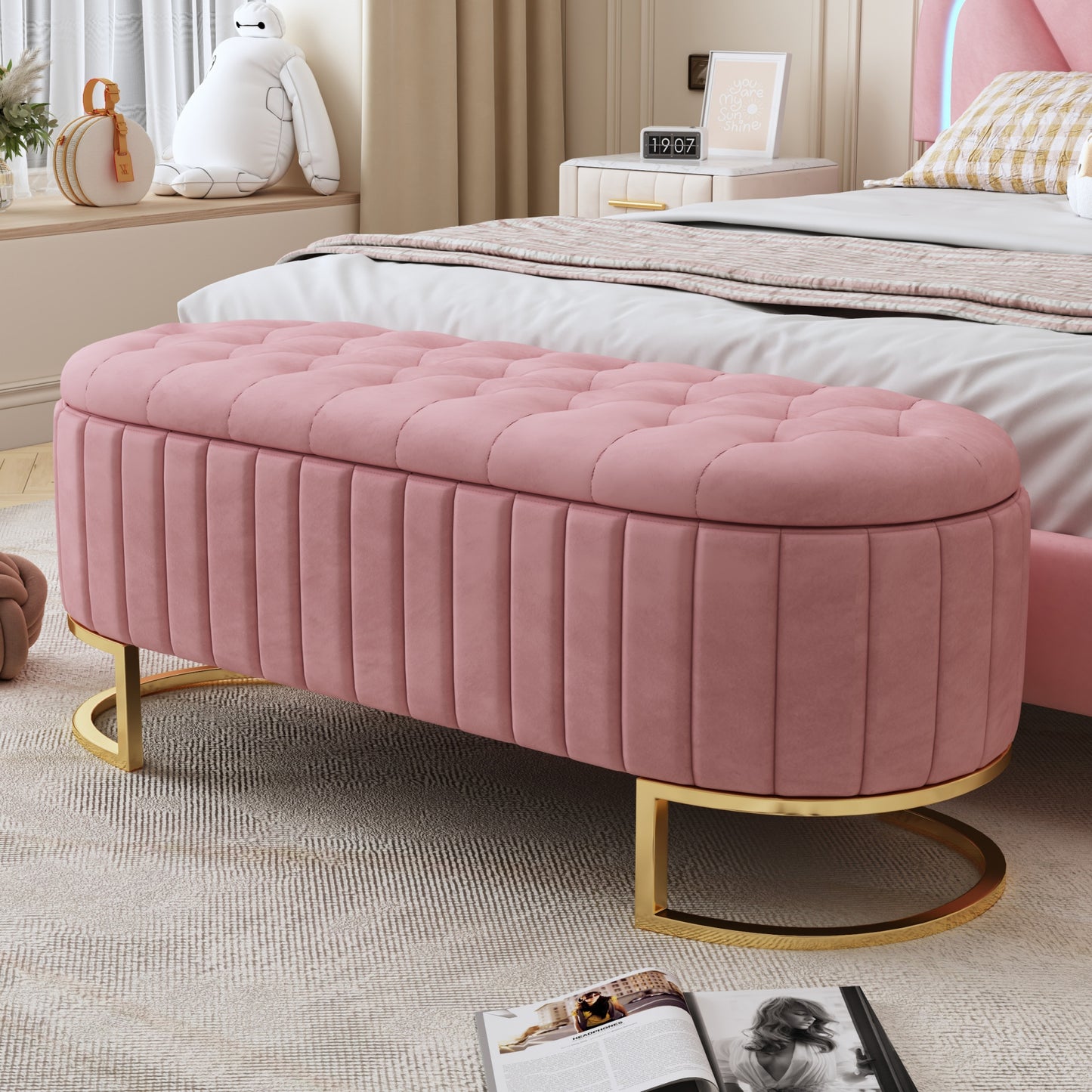 Pink velvet storage ottoman with button tufting and gold base