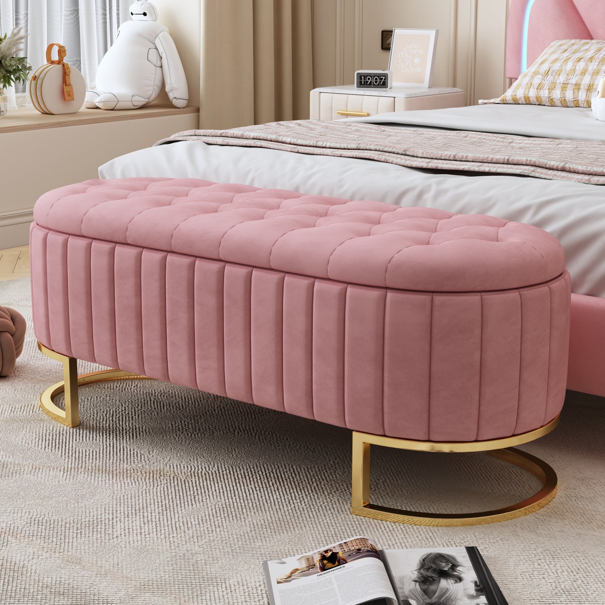 Pink velvet storage ottoman with button tufting and gold base