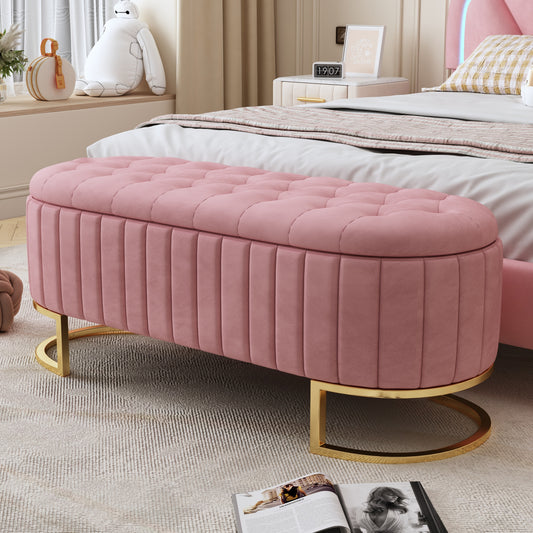 Pink velvet storage ottoman with button tufting and gold base