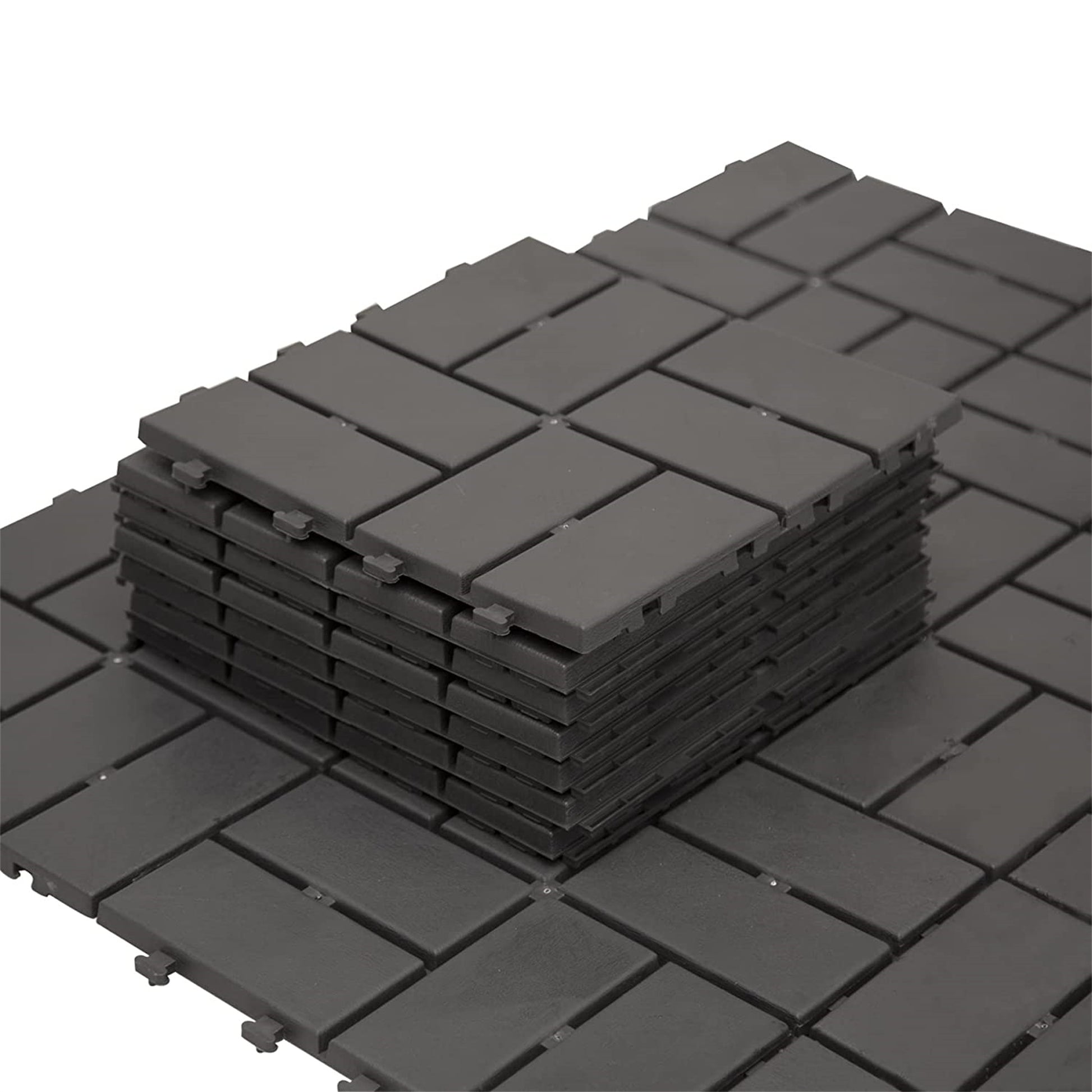 Stack of dark gray interlocking deck tiles ideal for patio flooring