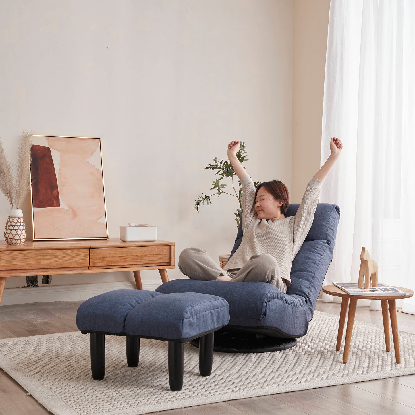 Blue fabric accent chair with adjustable reclining back and matching ottoman for ultimate relaxation