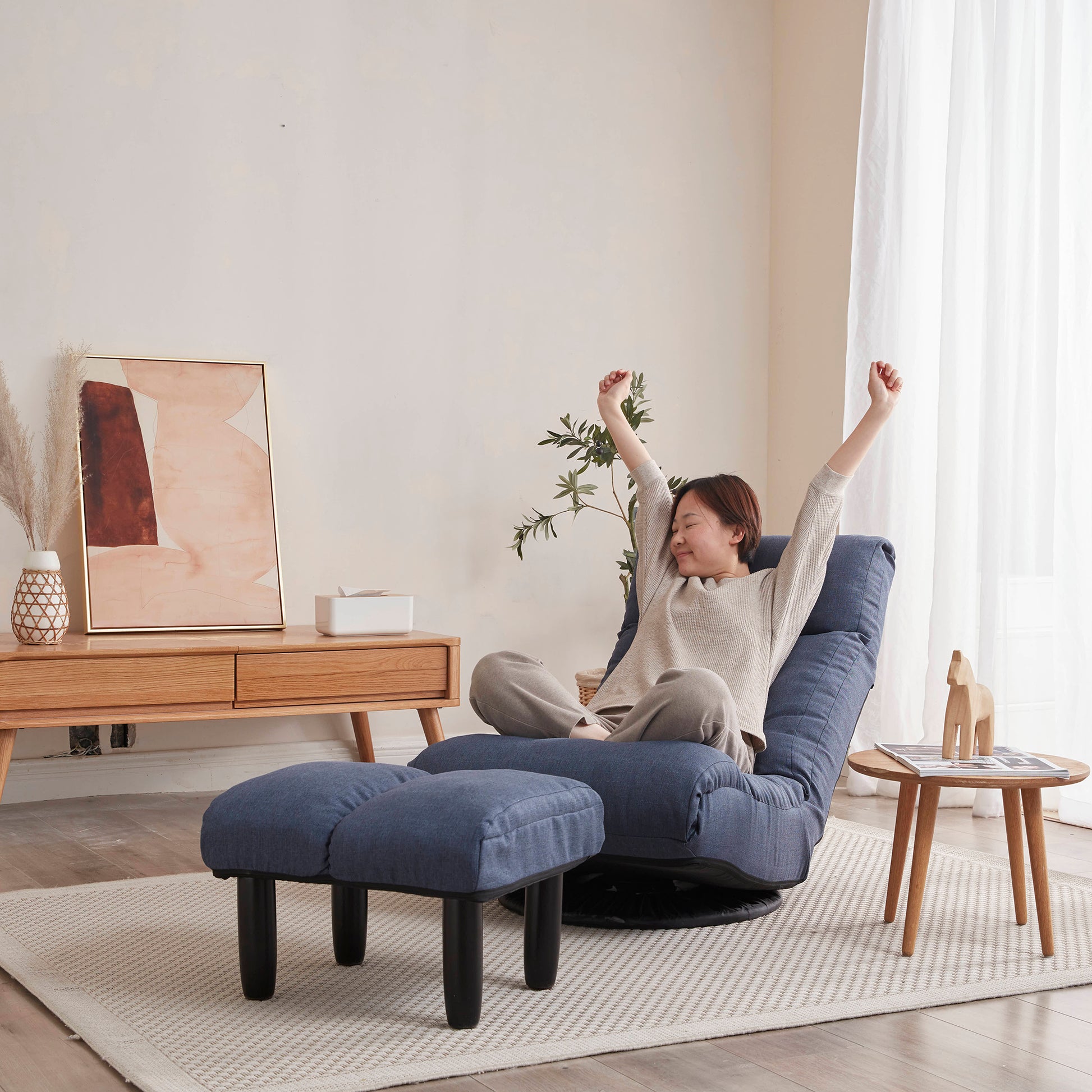 Blue fabric accent chair with adjustable reclining back and matching ottoman for ultimate relaxation