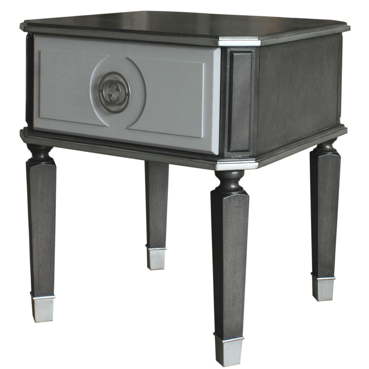 Charcoal grey wood end table with a single gray drawer featuring a silver double G logo emblem