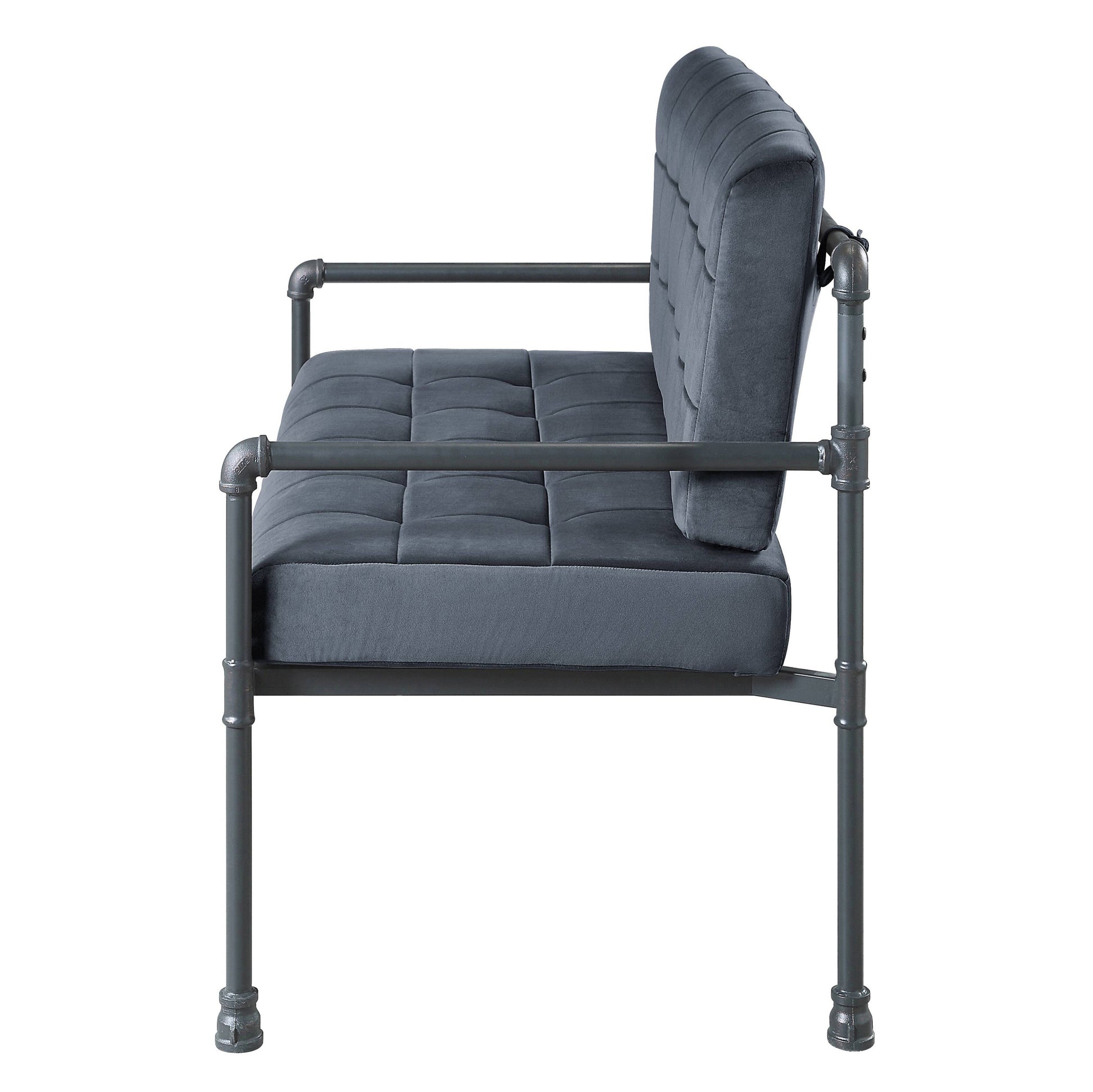 Dark grey velvet loveseat with tufted seat and backrest on industrial pipe frame