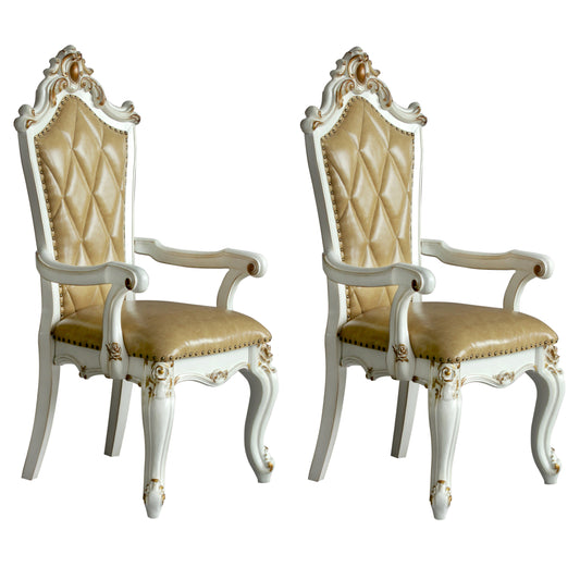 Ornate armchair with tufted tan leather upholstery and white carved wooden frame