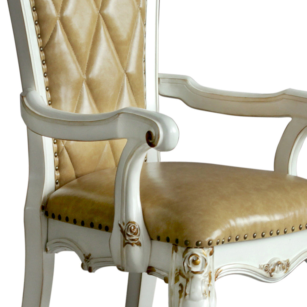 Tufted tan leather armchair with ornate antique white frame and gold accents