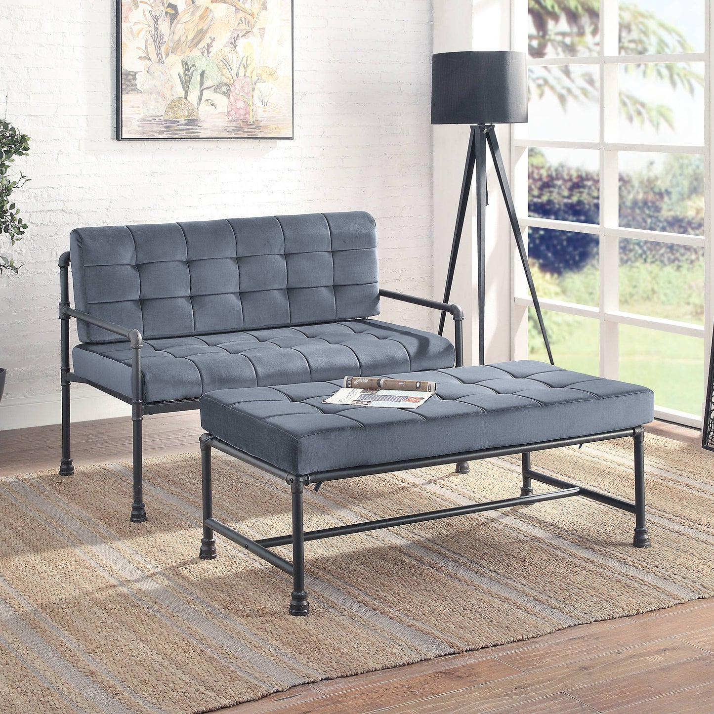 Grey velvet loveseat with tufted cushions and black metal frame