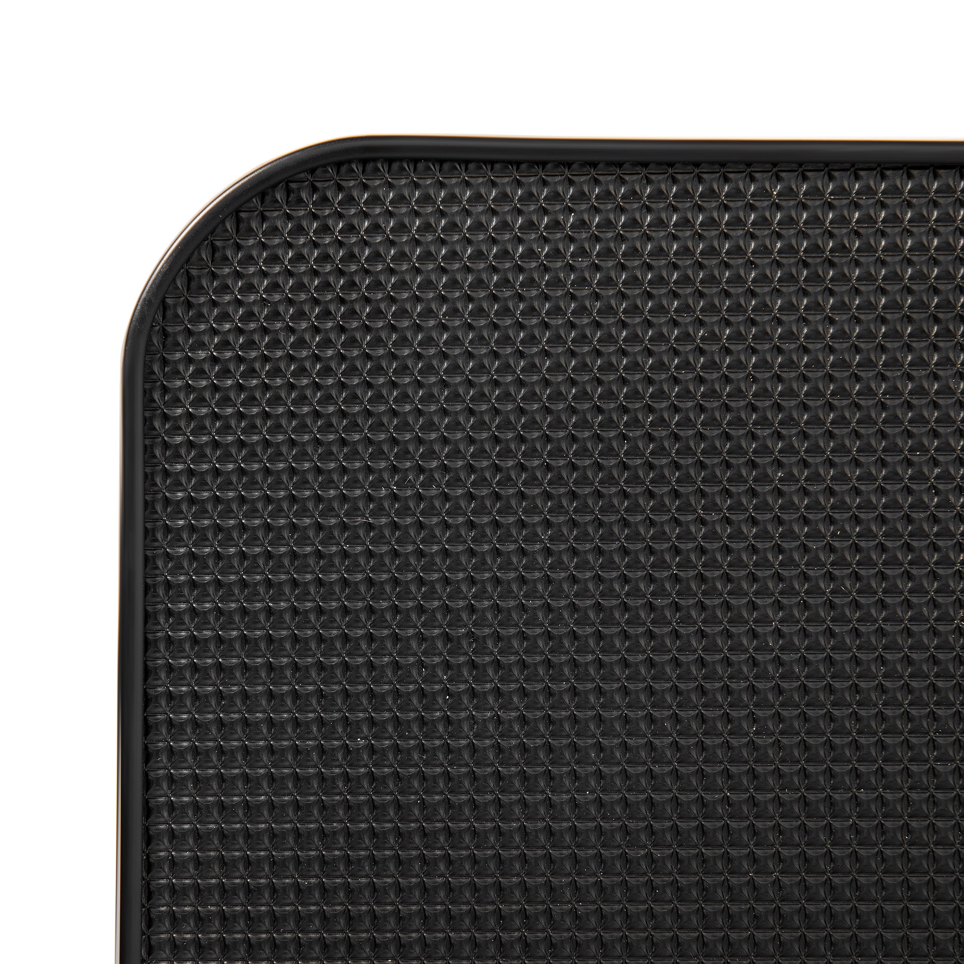 Black textured yoga mat with rounded corner detail for grip and stability