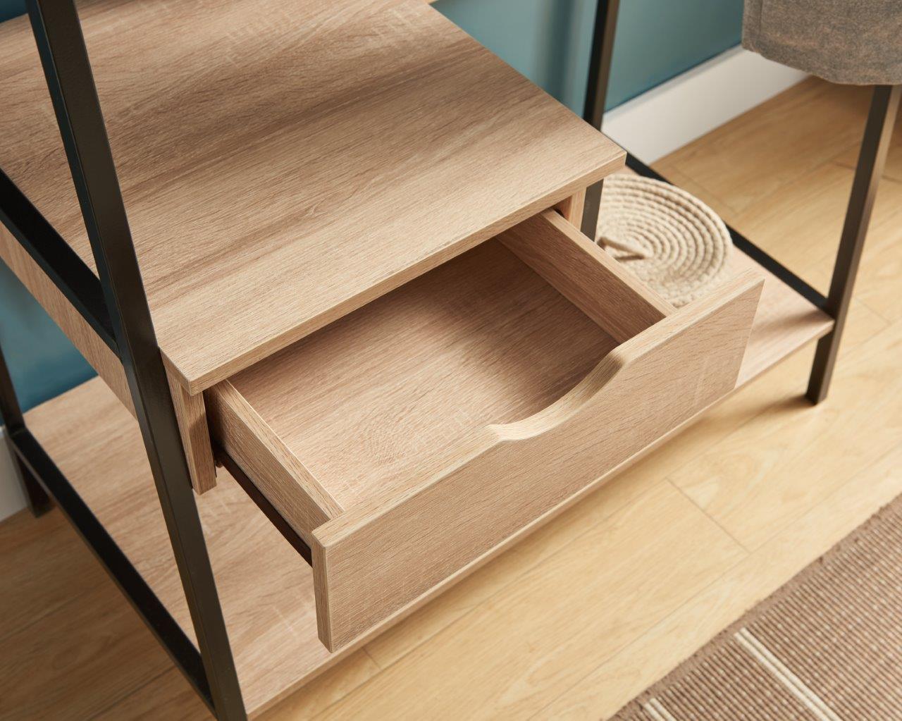 Light oak bookshelf with open drawer and black metal frame