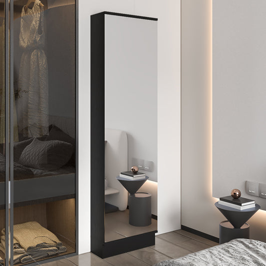 Tall blackframed floor mirror reflecting a modern bedroom with subtle lighting