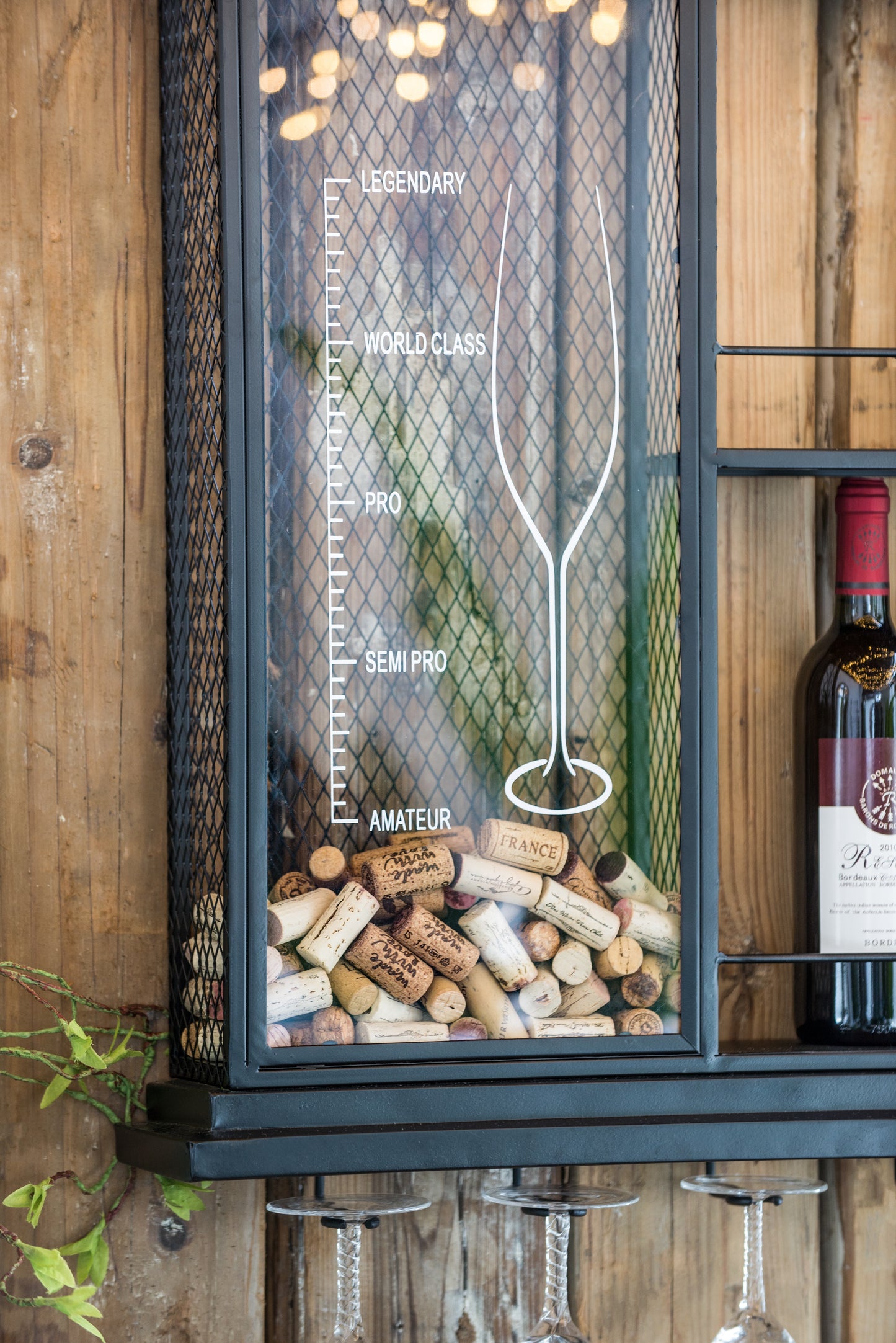 Black metal wallmounted wine cork display cabinet filled with wine corks