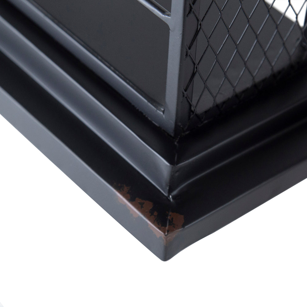 Close up of black metal fireplace hearth trim with distressed finish
