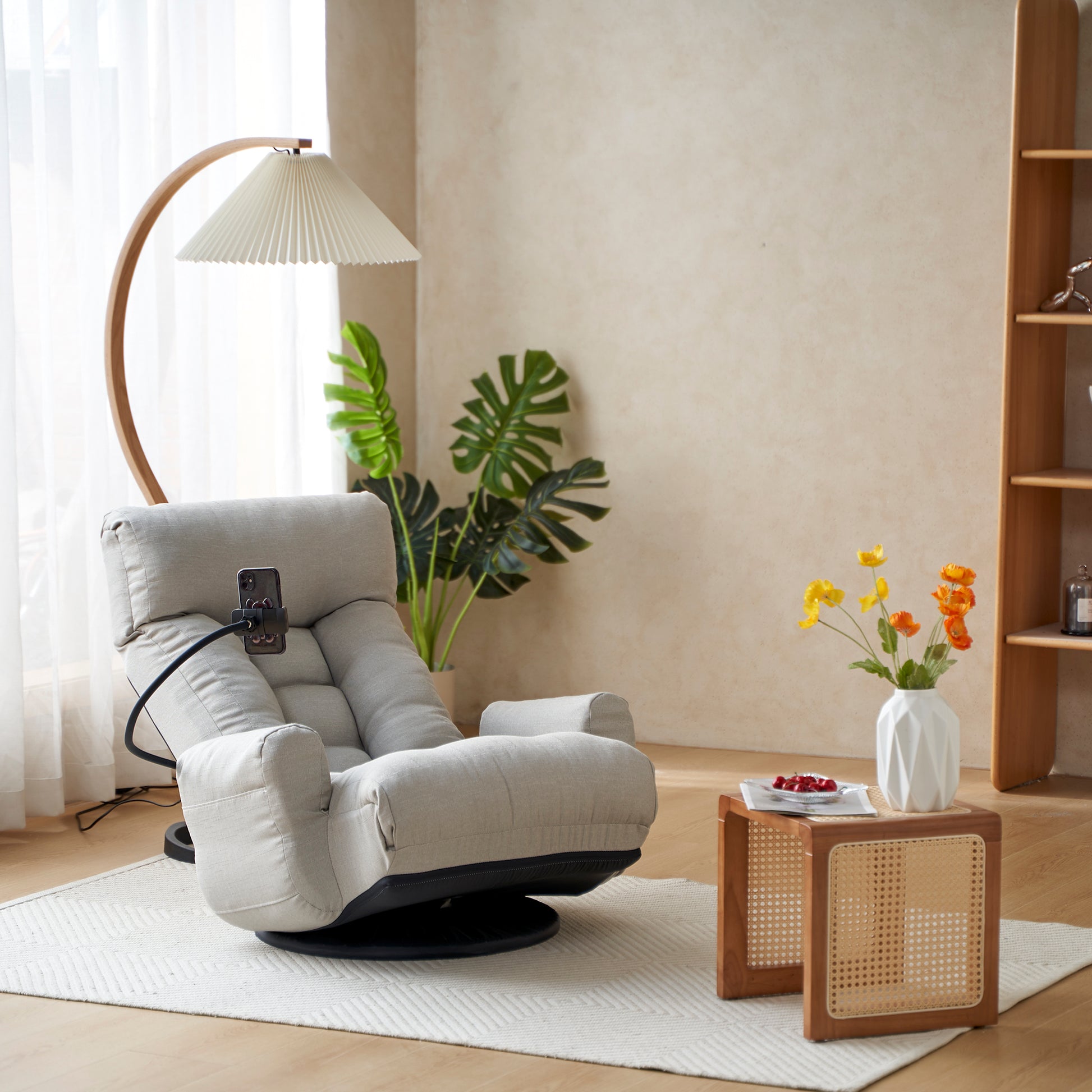 Plush grey fabric floor chair with adjustable backrest and integrated phone holder for ultimate comfort