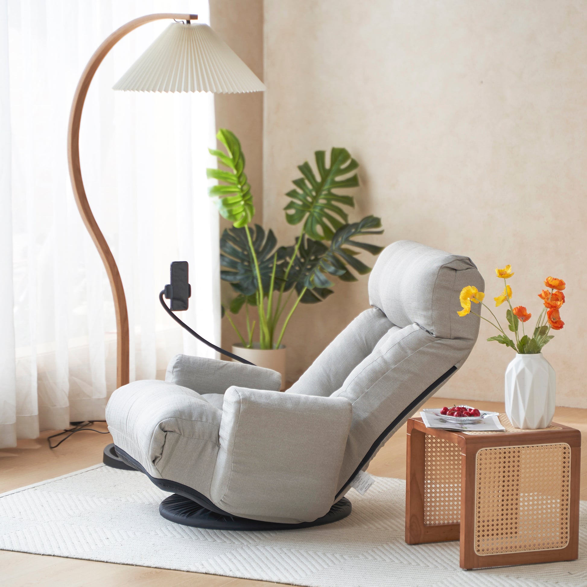 Light gray swivel recliner with adjustable headrest for ultimate comfort