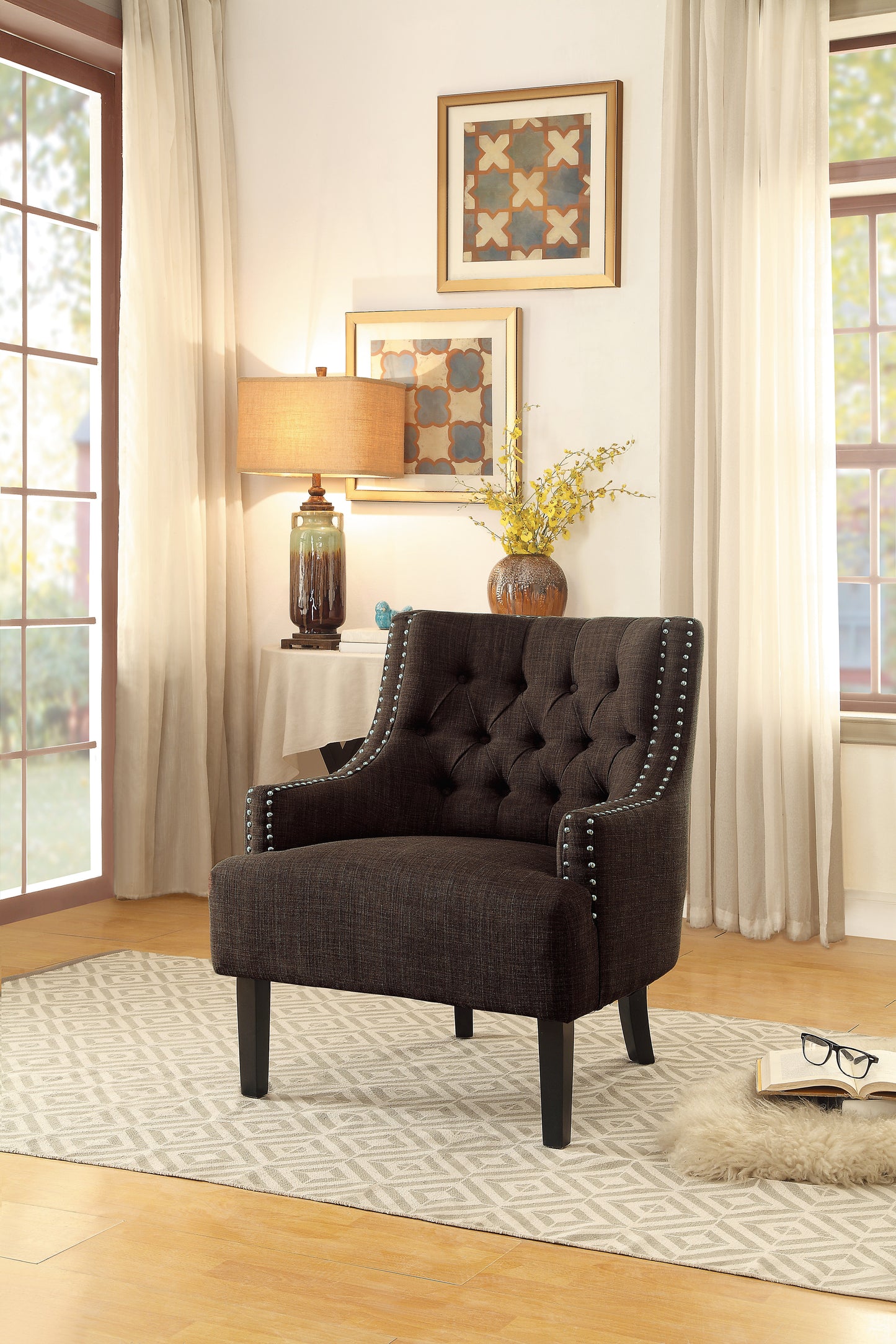 Dark brown tufted accent chair with silver nailhead trim and wooden legs