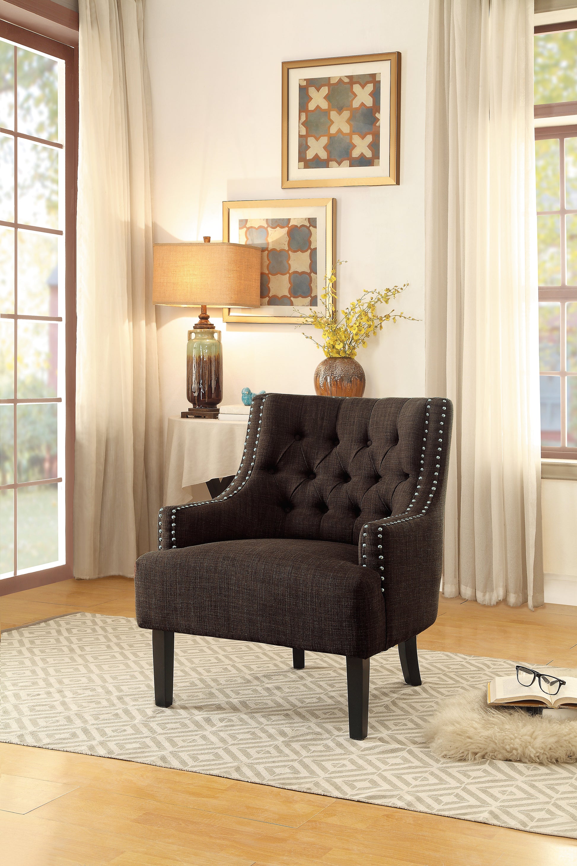 Dark brown tufted accent chair with silver nailhead trim and wooden legs