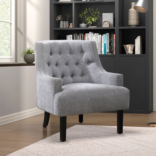 Tufted grey fabric accent chair with silver nailhead trim and dark wood legs