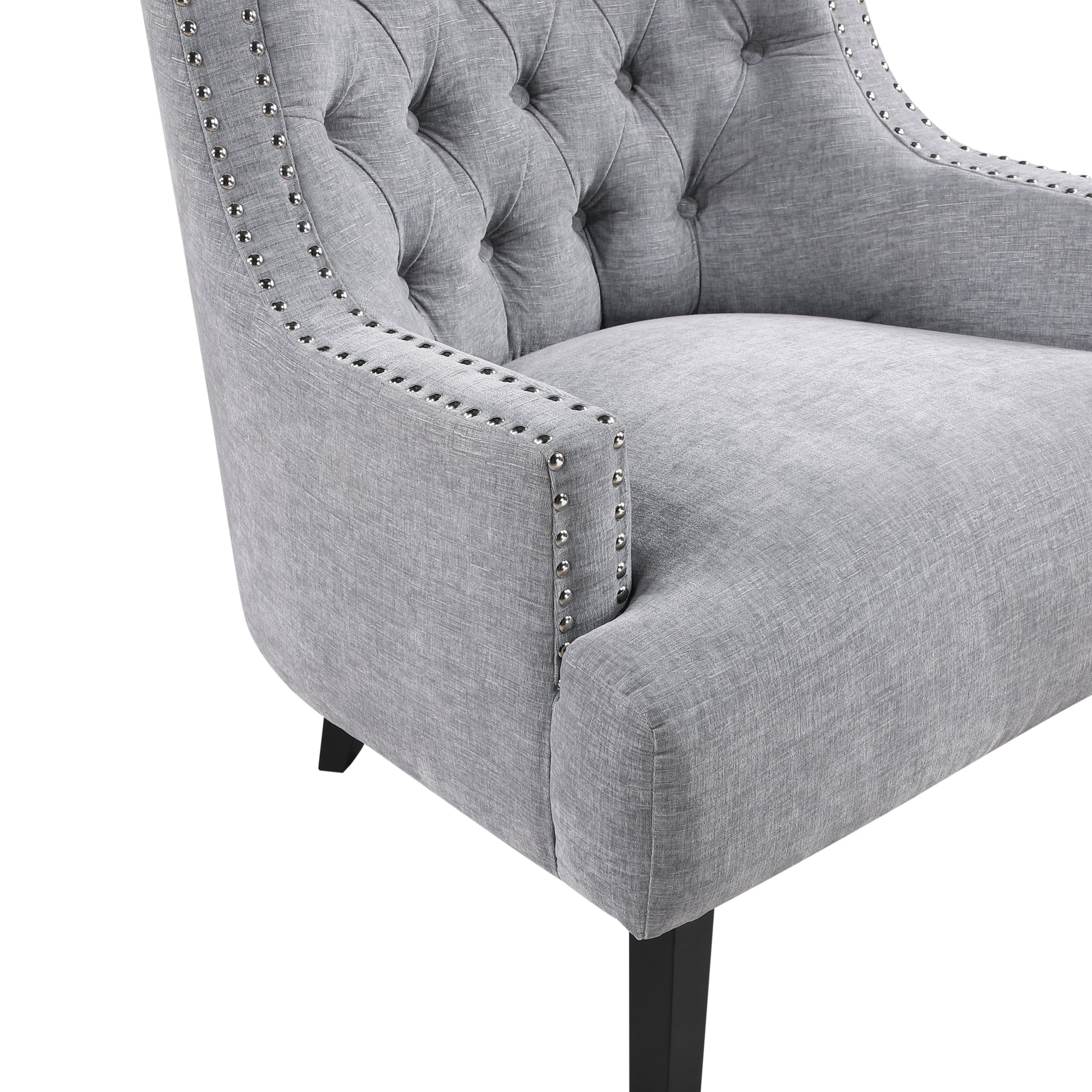 Tufted grey accent chair with silver nailhead trim and dark wooden legs