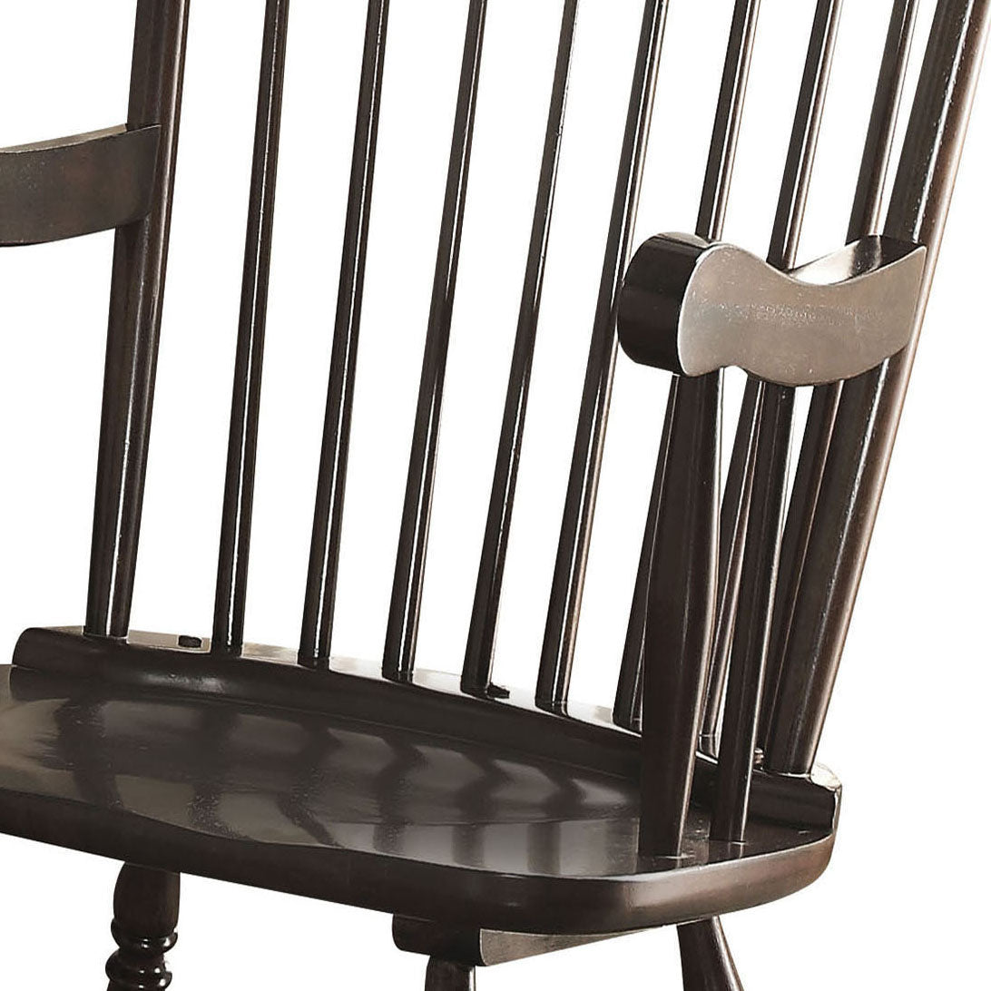 Dark brown Windsor chair armrest and spindle detail