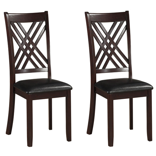 Pair of dark brown wooden dining chairs with black faux leather seats and crisscross backrests