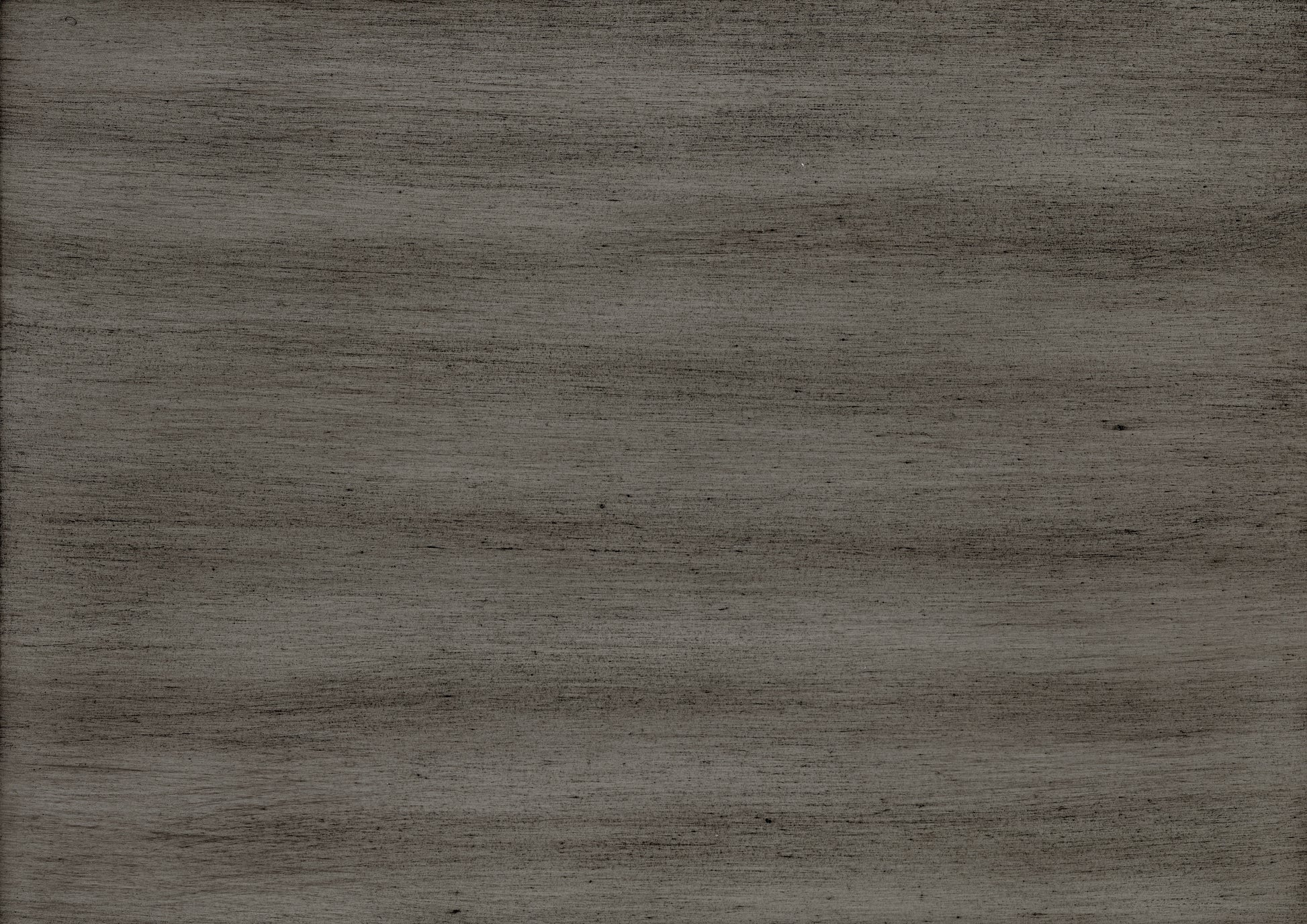 A closeup of a dark grey textured wood surface with visible grain
