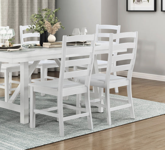 White wooden dining chairs with slatted backs and padded seats arranged around a table