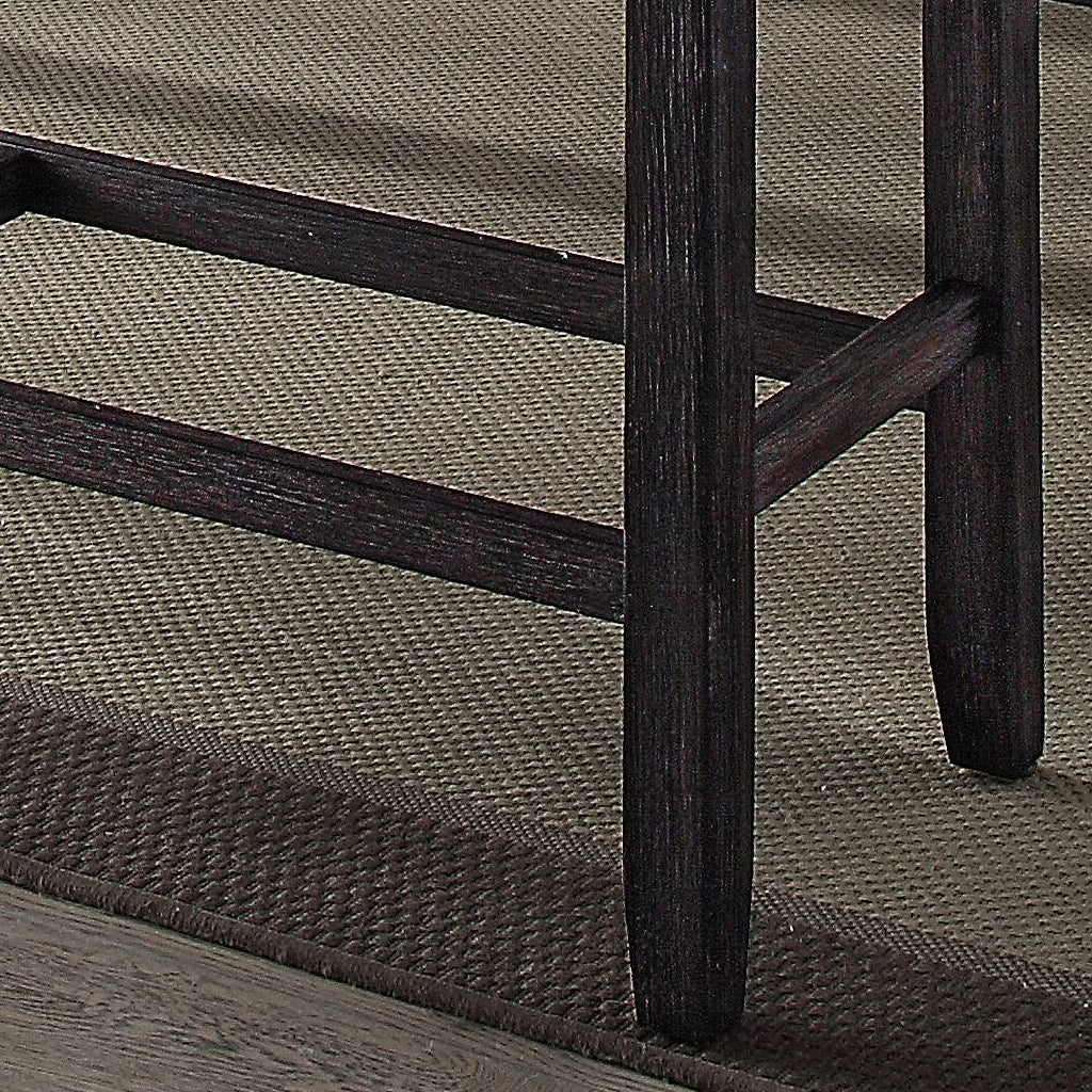 Dark wood bar stool legs with a textured rug beneath