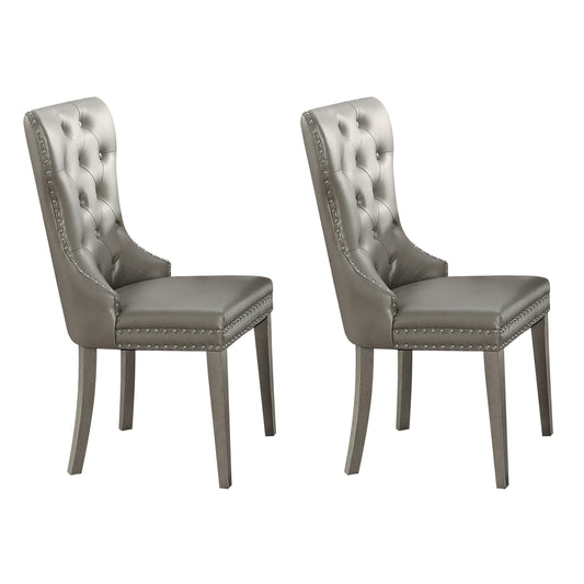 Two silver tufted dining chairs with nailhead trim and wooden legs