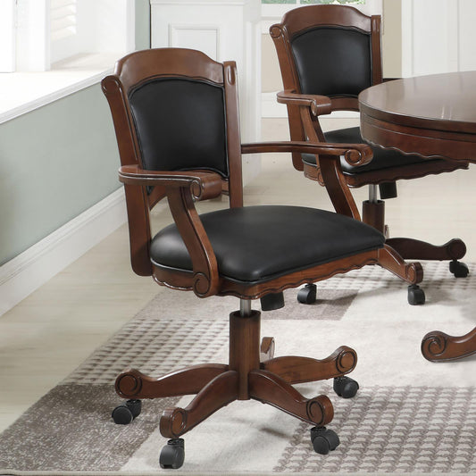 Ornate wooden desk chair with black leather seat and back on casters