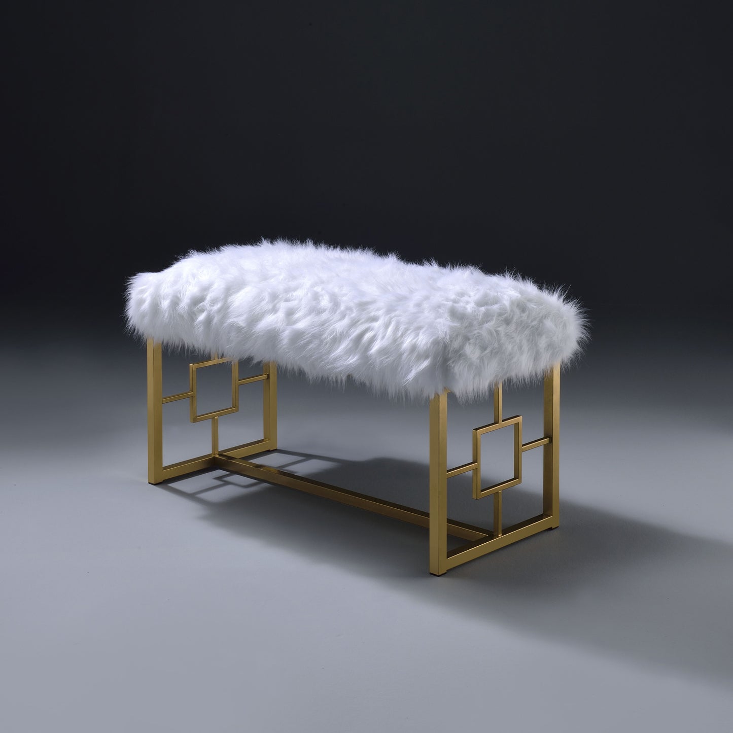 Plush white faux fur bench with a gold geometric frame perfect for entryways