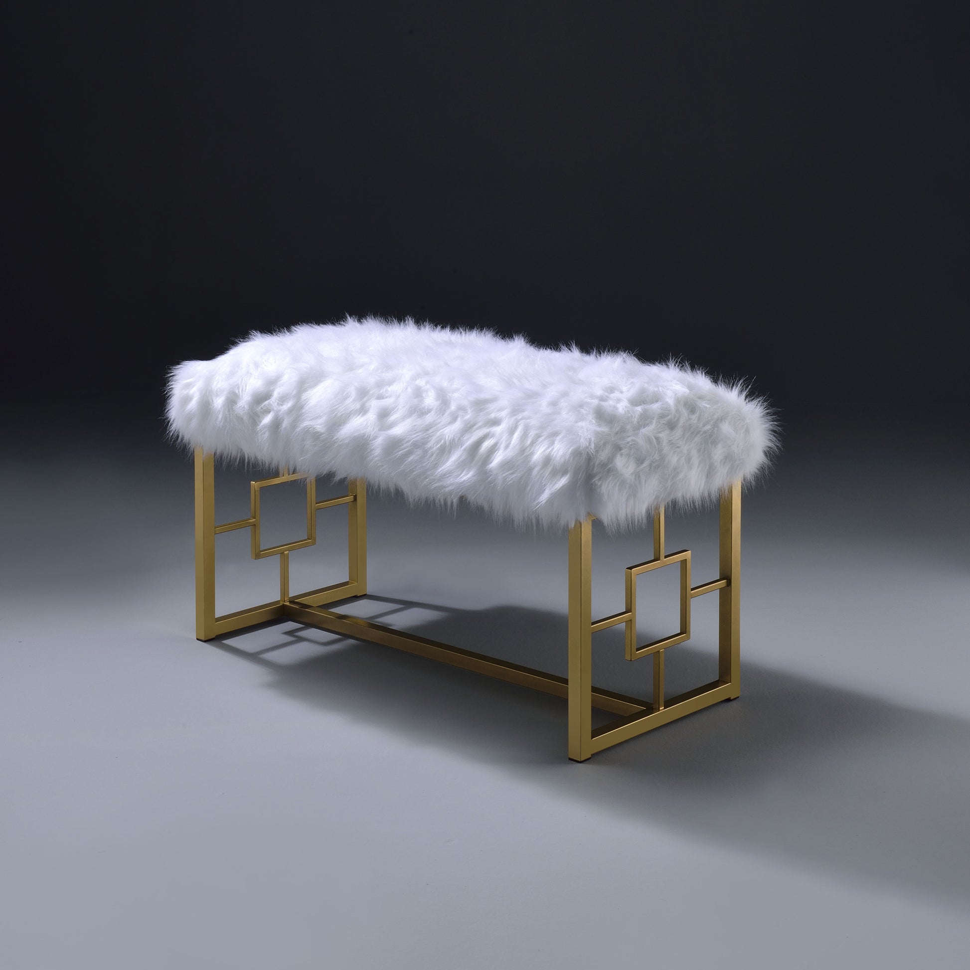 Plush white faux fur bench with a gold geometric frame perfect for entryways