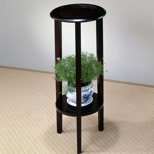 Dark wood plant stand with two circular shelves holding a potted green plant