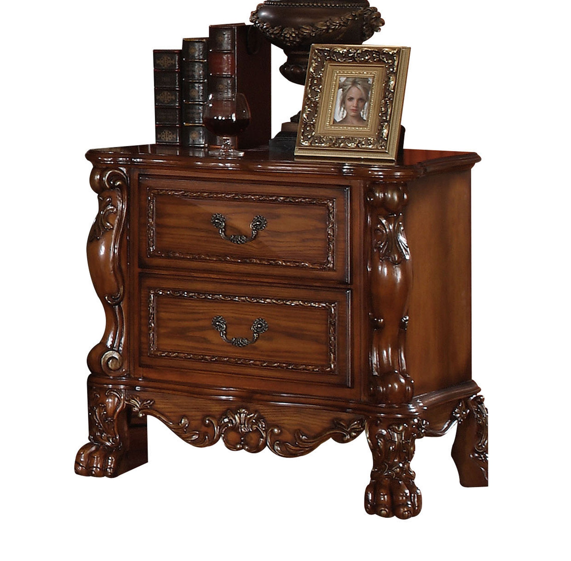 Antique carved mahogany nightstand with two drawers and ornate brass pulls