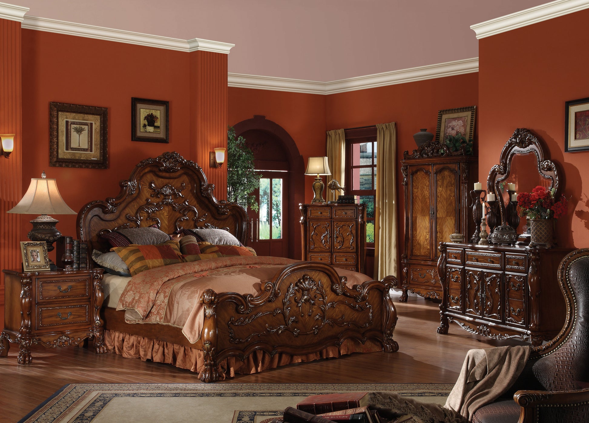 Ornate carved wood sleigh bed with patterned bedding and decorative pillows