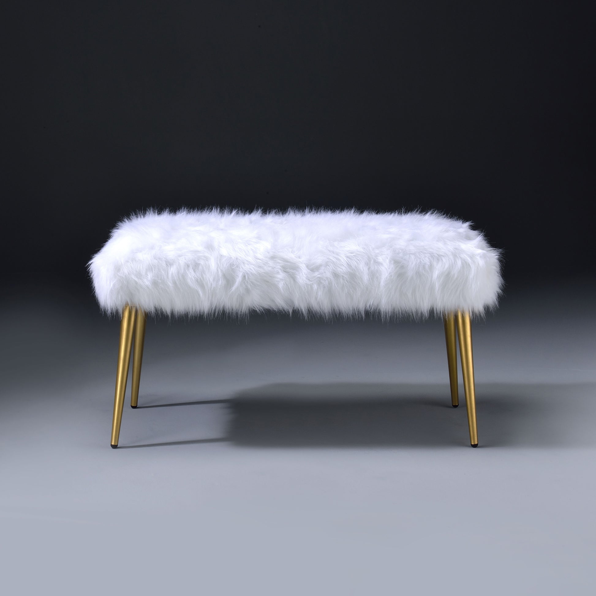 White fluffy ottoman with gold tapered legs