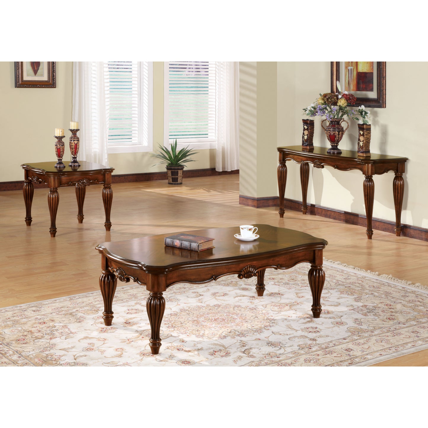 Ornate dark wood coffee table with carved legs and decorative trim holds a book and teacup