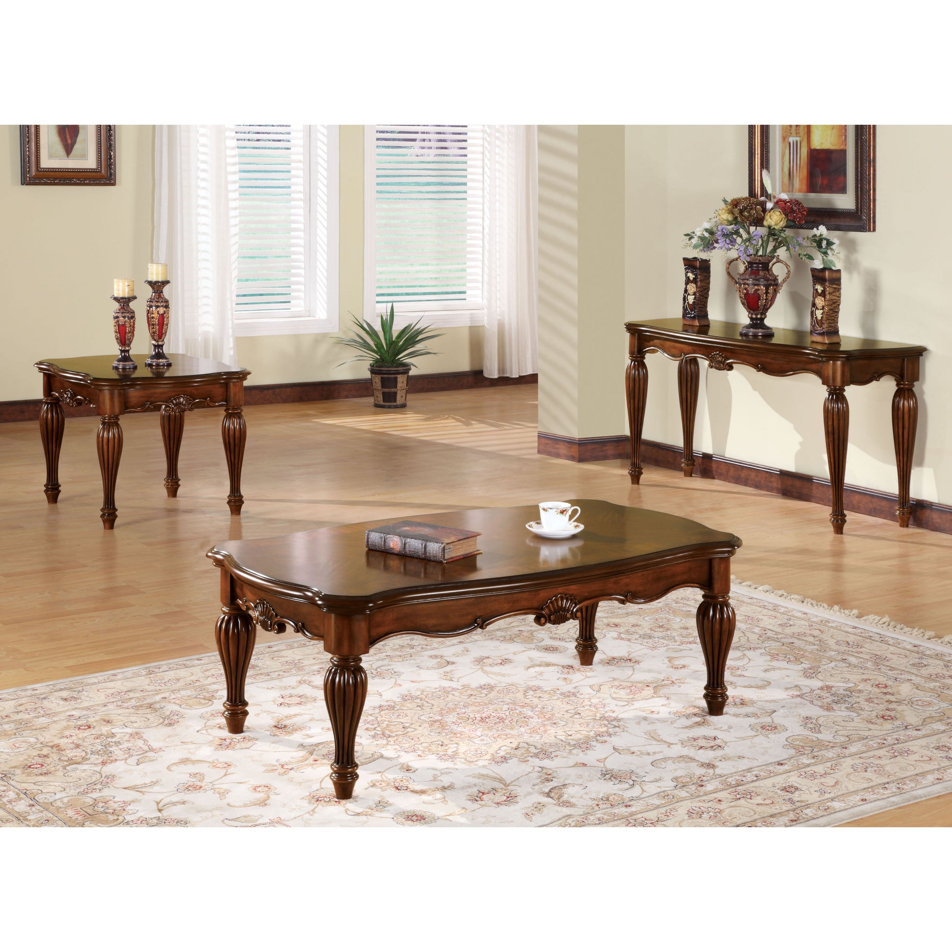 Ornate dark wood coffee table with carved legs and a single antique book