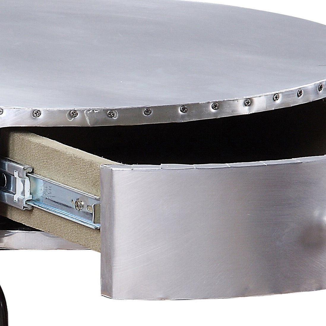 Brushed aluminum round coffee table with visible drawer slides and rivets